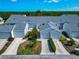 An aerial view of townhouses with attached garages, landscaped yards, and green foliage at 1316 Perico Point Cir, Bradenton, FL 34209