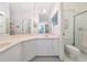 Well-lit bathroom with a spacious vanity, dual sinks and a glass enclosed shower at 1316 Perico Point Cir, Bradenton, FL 34209