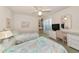 Cozy bedroom featuring twin beds, wicker furniture and a ceiling fan providing a comfortable retreat at 1316 Perico Point Cir, Bradenton, FL 34209