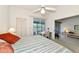 Bedroom featuring patio access, a desk, and view into the living room at 1316 Perico Point Cir, Bradenton, FL 34209