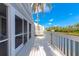 A sun-filled waterfront deck with white railings offers scenic views and outdoor living space at 1316 Perico Point Cir, Bradenton, FL 34209