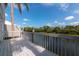 A sun-filled waterfront deck with white railings offers scenic views and outdoor living space at 1316 Perico Point Cir, Bradenton, FL 34209