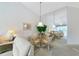 Cozy dining area with glass table, leading into living room with view of the lanai at 1316 Perico Point Cir, Bradenton, FL 34209