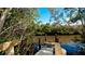 Private wooden dock surrounded by lush greenery, leading to tranquil waters at 1316 Perico Point Cir, Bradenton, FL 34209