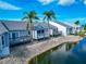 A beautiful view of waterfront townhouses with palm trees along the edge of the waterway at 1316 Perico Point Cir, Bradenton, FL 34209