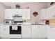 Bright kitchen with white cabinets, white appliances, and ample counter space at 1316 Perico Point Cir, Bradenton, FL 34209