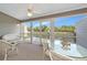 Enclosed lanai with waterfront views, wicker furniture, and ceiling fan, perfect for relaxation at 1316 Perico Point Cir, Bradenton, FL 34209