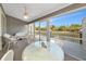 Enclosed lanai with waterfront views, wicker furniture, and ceiling fan, perfect for relaxation at 1316 Perico Point Cir, Bradenton, FL 34209