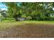 Expansive backyard featuring a storage shed and mature trees, offering privacy and space at 1354 22Nd St, Sarasota, FL 34234