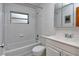 Classic bathroom with white tile, bathtub, and vanity with storage at 1354 22Nd St, Sarasota, FL 34234