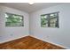 Bedroom featuring hardwood floors and two bright windows at 1354 22Nd St, Sarasota, FL 34234
