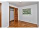 Bedroom with hardwood floors, closet with sliding doors and a bright window at 1354 22Nd St, Sarasota, FL 34234