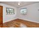 Bedroom with hardwood floors, ceiling fan, and natural light from the windows at 1354 22Nd St, Sarasota, FL 34234