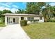 Charming single-story home featuring a well-maintained lawn, a convenient carport, and a freshly painted exterior at 1354 22Nd St, Sarasota, FL 34234