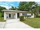 Charming single-story home featuring a covered parking, well-maintained lawn and curb appeal at 1354 22Nd St, Sarasota, FL 34234