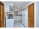 Updated kitchen with white cabinets, appliances, neutral countertop, and tile floors at 1354 22Nd St, Sarasota, FL 34234