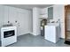 Laundry room equipped with modern washer, dryer, water heater and white door at 1354 22Nd St, Sarasota, FL 34234