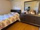 Small bedroom featuring a queen bed and a dresser with a large mirror at 1506 S 78Th S St, Tampa, FL 33619