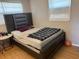 Bedroom with a queen sized bed, modern headboard, and a small side table at 1506 S 78Th S St, Tampa, FL 33619