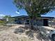 Charming single-story home featuring a covered carport and mature trees in the front yard at 1506 S 78Th S St, Tampa, FL 33619