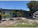 Single-story home showing mature landscaping, complete with exterior shutters at 1506 S 78Th S St, Tampa, FL 33619