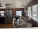 Kitchen with stainless steel appliances, wood paneling, and a dining area near the window at 1506 S 78Th S St, Tampa, FL 33619