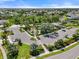 Aerial shot of community amenities showcasing a playground, resort-style pool, and ample parking at 15316 Shady Palms Ln, Nokomis, FL 34275