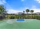 Outdoor basketball court with lush landscaping, a water view, and secure fencing at 15316 Shady Palms Ln, Nokomis, FL 34275