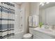 Well-lit bathroom showcasing a shower/tub combo, and white sink and vanity at 15316 Shady Palms Ln, Nokomis, FL 34275