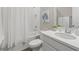 Bright bathroom featuring a shower-tub combination, white vanity, and modern fixtures at 15316 Shady Palms Ln, Nokomis, FL 34275