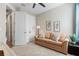 Bright bedroom featuring a couch, ceiling fan, and closet at 15316 Shady Palms Ln, Nokomis, FL 34275