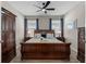 Comfortable bedroom featuring a full-size bed, decorative lamps, and soft, inviting decor at 15316 Shady Palms Ln, Nokomis, FL 34275
