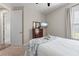This bedroom features neutral colors and a dresser with mounted television at 15316 Shady Palms Ln, Nokomis, FL 34275