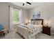 This is a bright bedroom with a comfy bed, large window, and decorative accents at 15316 Shady Palms Ln, Nokomis, FL 34275