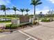 Elegant community entrance sign for Palmero Sarasota surrounded by lush landscaping, and brick-paved roads at 15316 Shady Palms Ln, Nokomis, FL 34275