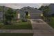Charming single-story home boasts a manicured lawn, two-car garage, and inviting curb appeal at 15316 Shady Palms Ln, Nokomis, FL 34275