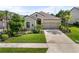 A charming single-Gathering home featuring manicured landscaping and a two-car garage at 15316 Shady Palms Ln, Nokomis, FL 34275