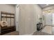 Welcoming hallway showcasing an entry table with decor and a coat rack with bench seating at 15316 Shady Palms Ln, Nokomis, FL 34275