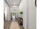Bright hallway with wood-look tile floors and neutral walls providing a welcoming atmosphere at 15316 Shady Palms Ln, Nokomis, FL 34275