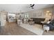 Wide angle of living room showing barstool seating, dining area, leather couch and tile floors at 15316 Shady Palms Ln, Nokomis, FL 34275