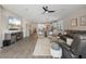 Open-concept living room featuring modern decor, wood-look tile floors, and ample natural light at 15316 Shady Palms Ln, Nokomis, FL 34275