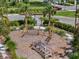 Community playground with climbing structures surrounded by landscaped grounds and palm trees at 15316 Shady Palms Ln, Nokomis, FL 34275