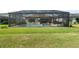A private backyard featuring a screened-in pool and a modern outdoor entertainment area at 15316 Shady Palms Ln, Nokomis, FL 34275
