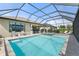 Backyard pool area features a spa, patio with seating, and a screened enclosure at 15316 Shady Palms Ln, Nokomis, FL 34275