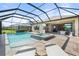 Expansive pool and patio area includes a heated spa, outdoor kitchen, and lounging space at 15316 Shady Palms Ln, Nokomis, FL 34275