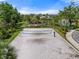 Community volleyball court with blue net surrounded by palm trees and well-kept landscaping at 15316 Shady Palms Ln, Nokomis, FL 34275