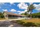 Spacious backyard with screened lanai, white picket fence, pool, and mature trees offers privacy at 15440 County Road 675, Parrish, FL 34219
