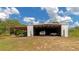 Large metal barn with open storage, providing shelter for vehicles and equipment on the property at 15440 County Road 675, Parrish, FL 34219