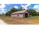 Rustic red barn with open bay offers ample storage for equipment and farm needs, great for country living at 15440 County Road 675, Parrish, FL 34219