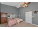 Bedroom featuring gray walls, a ceiling fan, built-in cabinets, and neutral carpeting at 15440 County Road 675, Parrish, FL 34219
